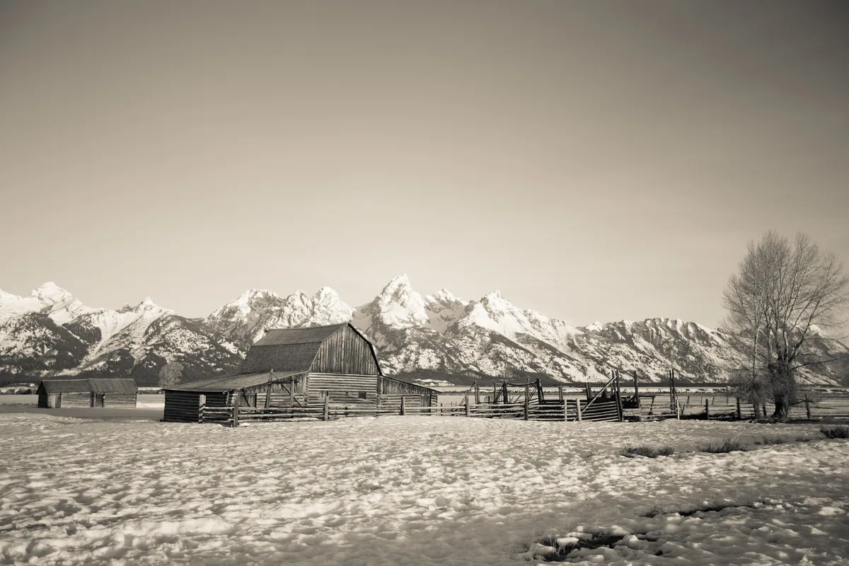 The Moulton Barn on Mormon Row under deep snow, the Teton Range behind it.
